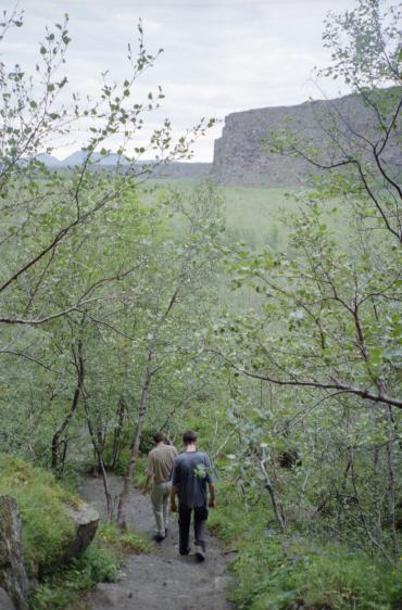 Dave and Gordon walking through the trees inside sbyrgi