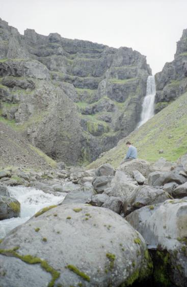 Gordon sitting by the waterfall