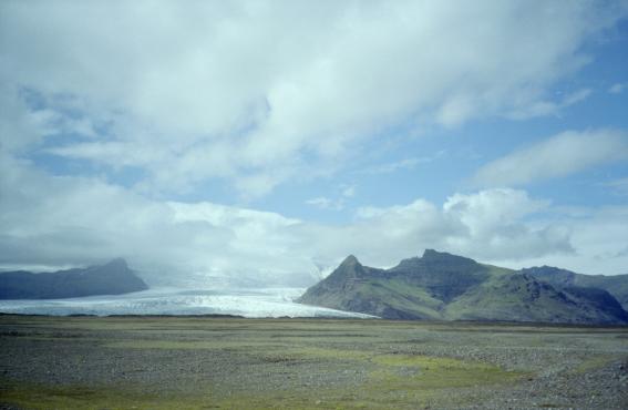 The tongue of a glacier between two mountain outcrops